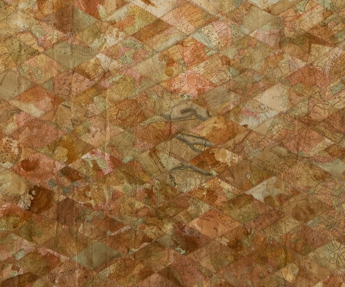 a detail of an artwork made from old maps that have been deconstructed and reassembled into a pattern