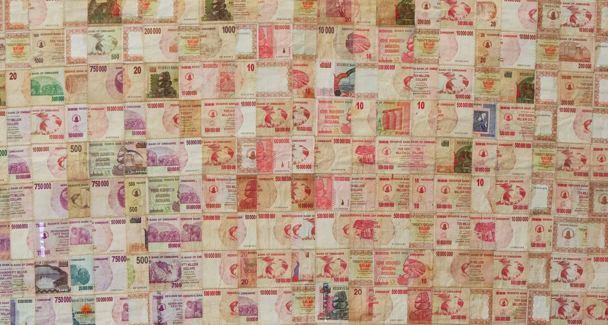 a detail of an artwork made from discontinued currency notes that have been deconstructed and reassembled into a grid pattern