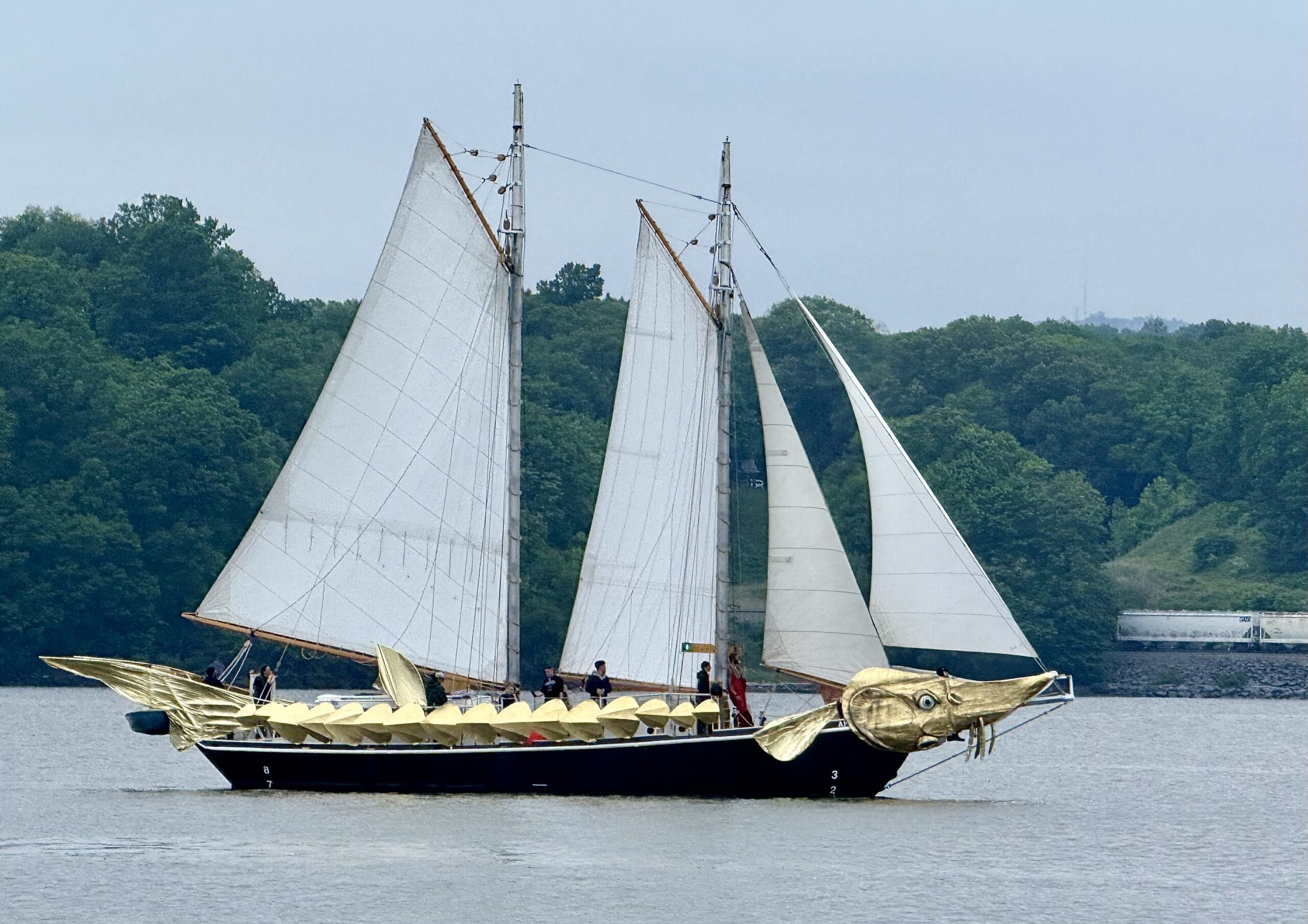 a sailing ship on the Hudson River with gold decorations to make it look like a fish