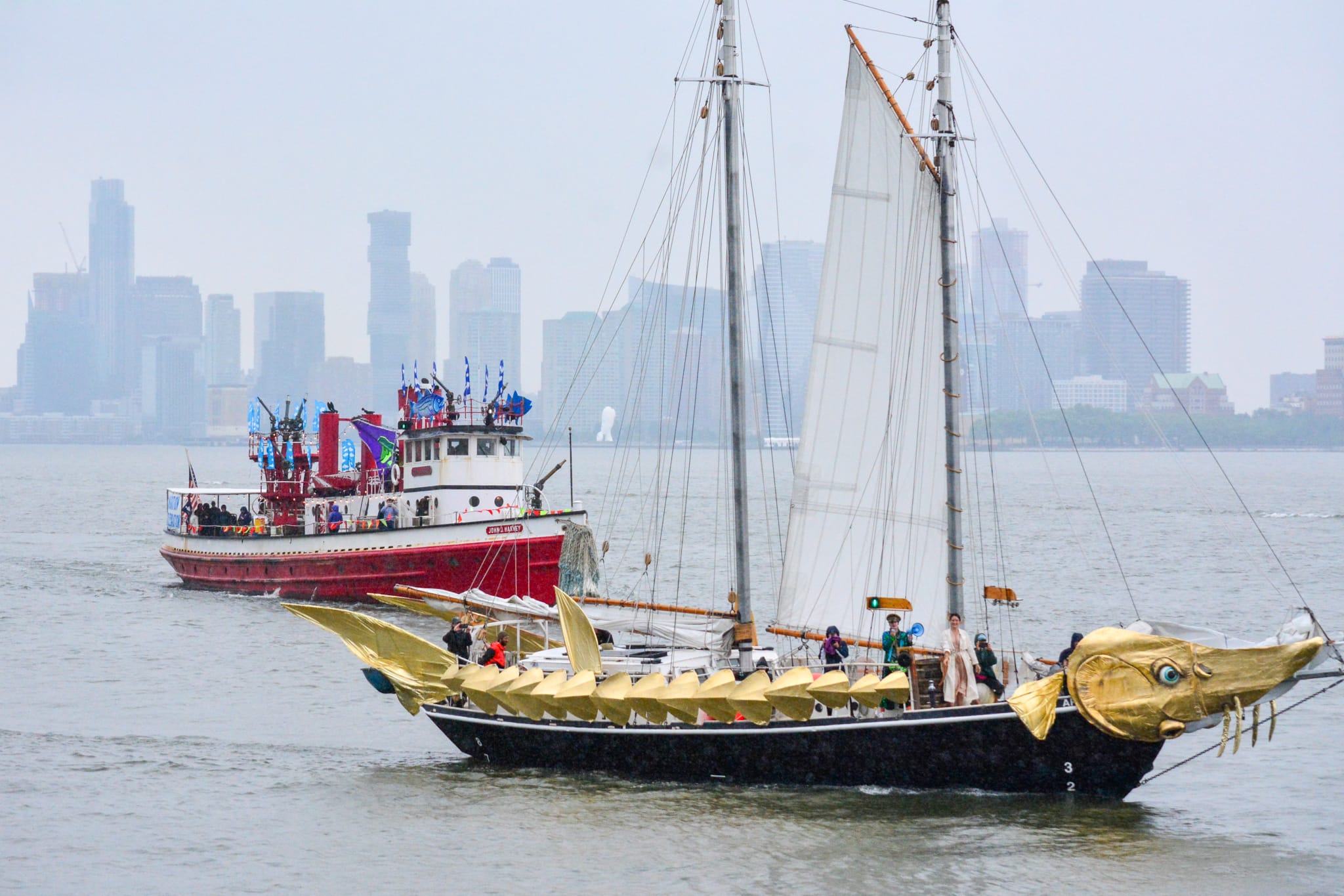 two small ships on the Hudson River decorated with fish-themed ornamentation