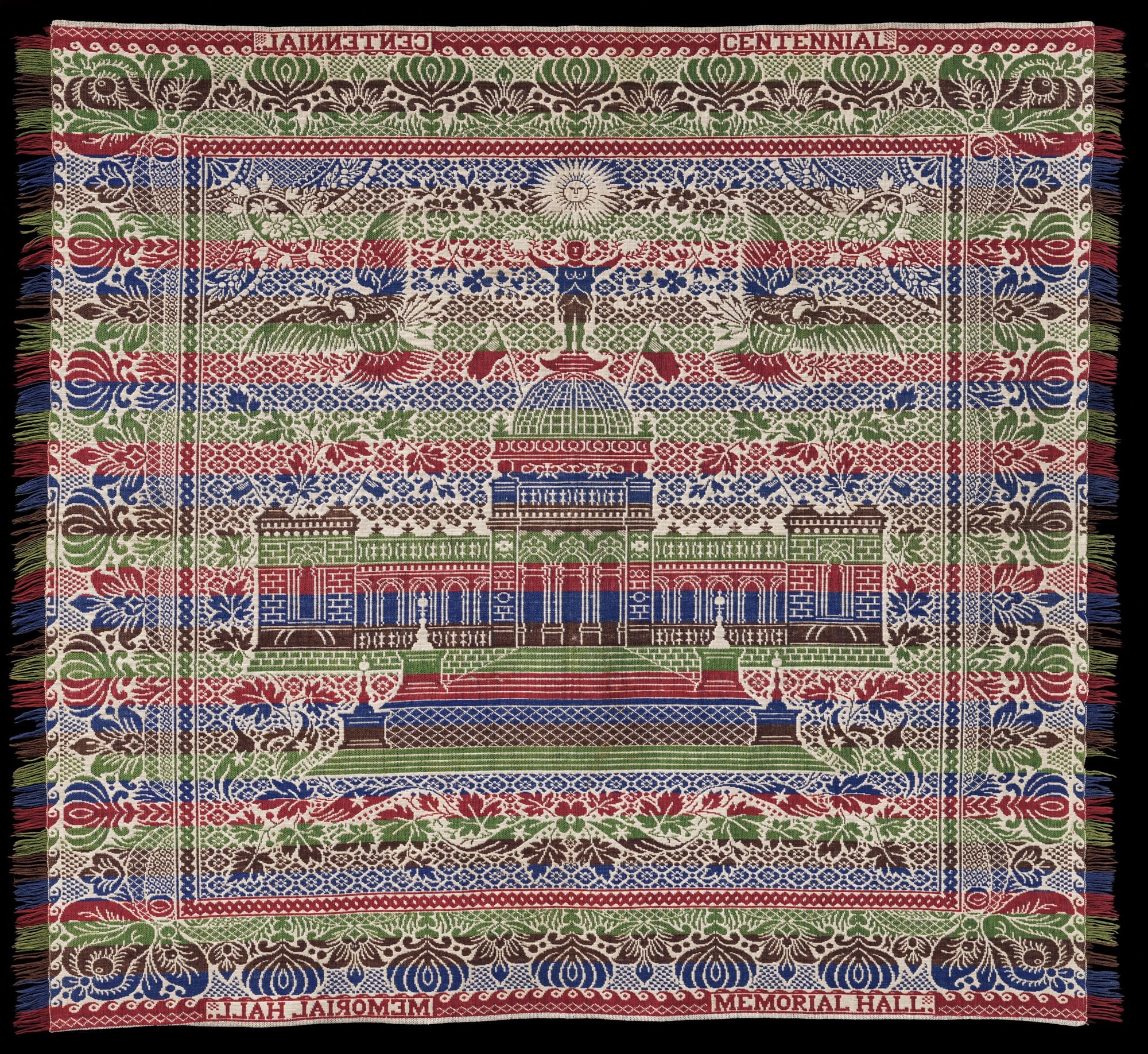 a colorful ,striped quilt with a large classical building in the center, flanked by eagles