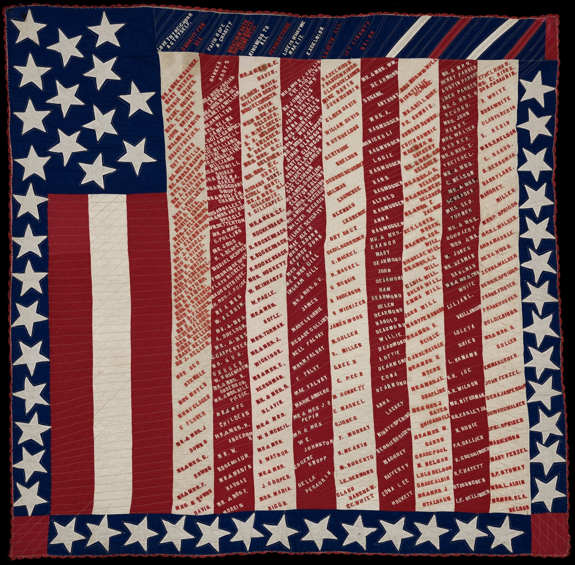 a quilt in the shape of an American flag, with the stripes embroidered with the names of people who may have been suffrage supporters