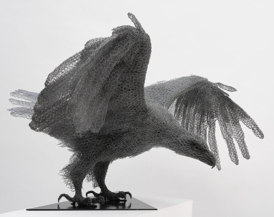 a life-size wire sculpture of an eagle with wings spread