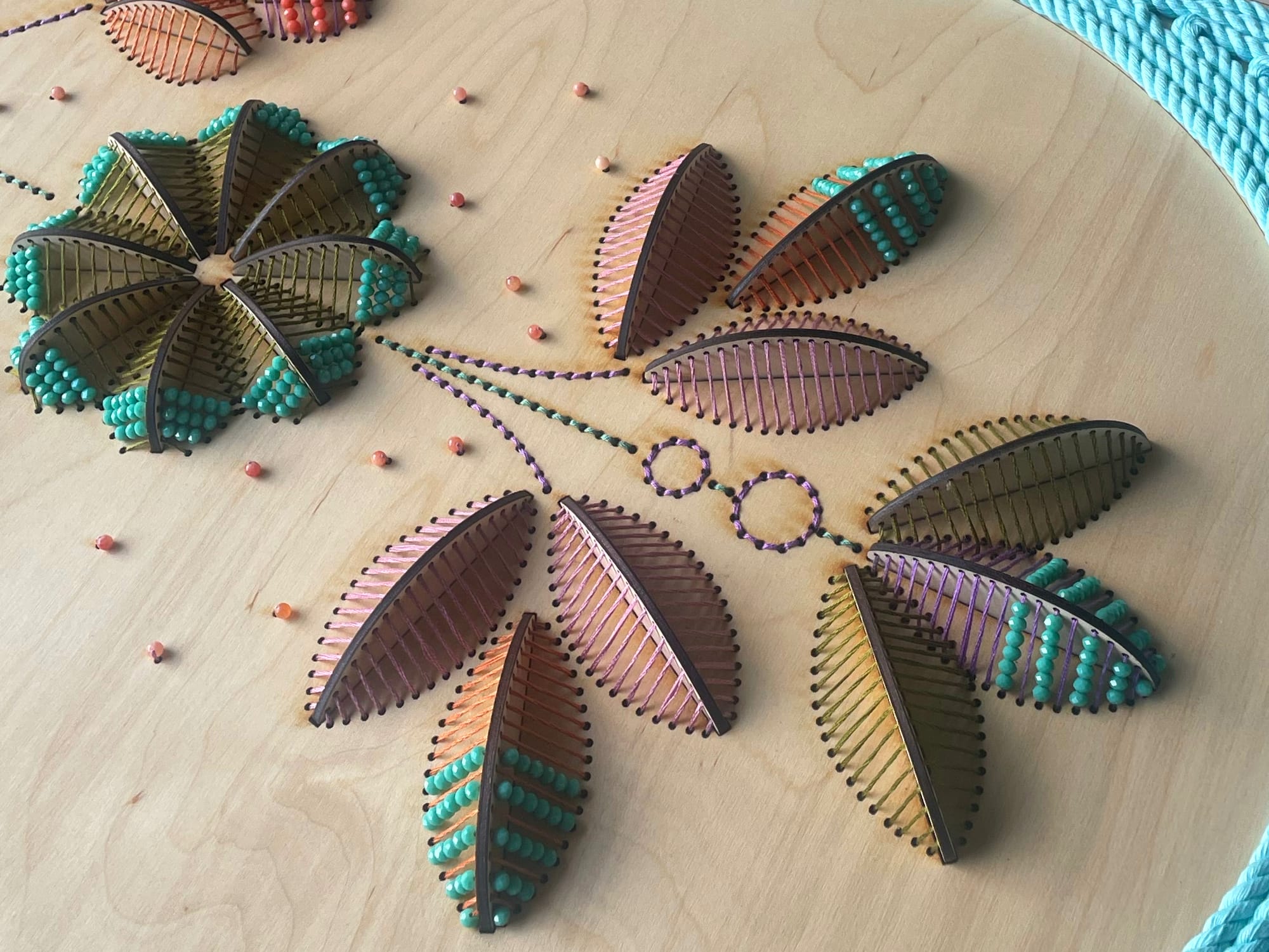 a close up of sculptural floral embroideries on wood