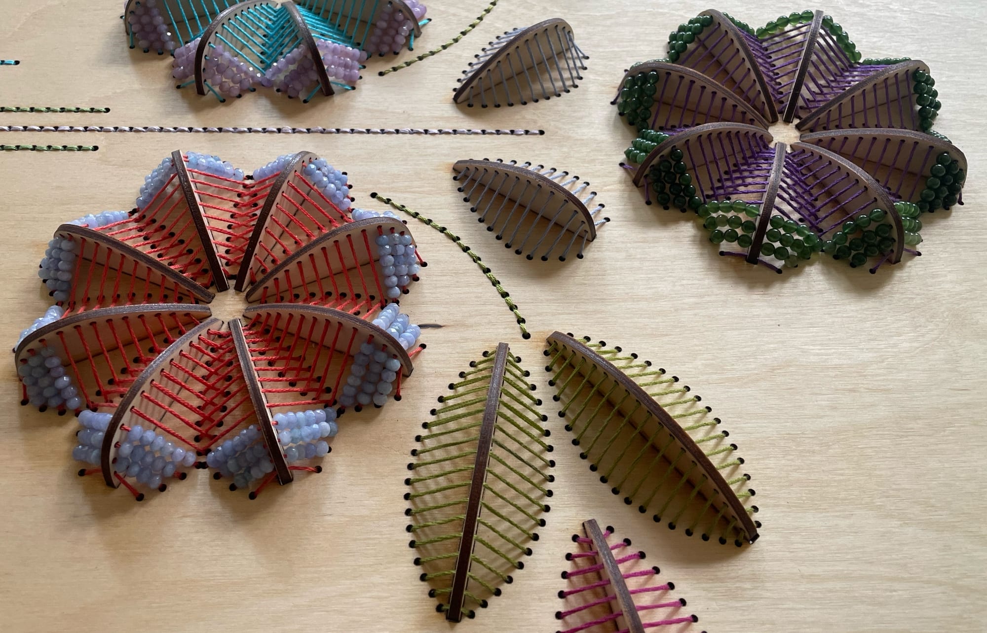a close up of sculptural floral embroideries on wood