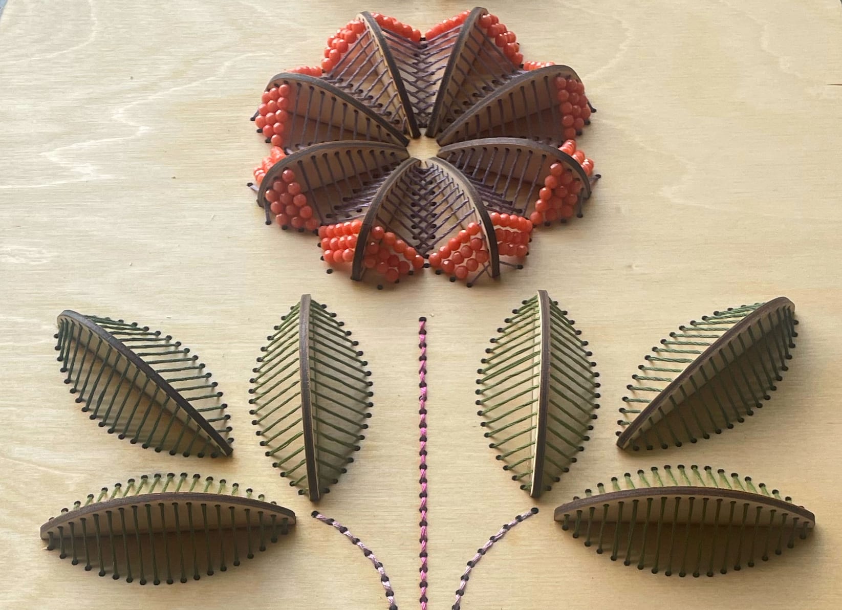 a close up of a sculptural floral embroidery on wood