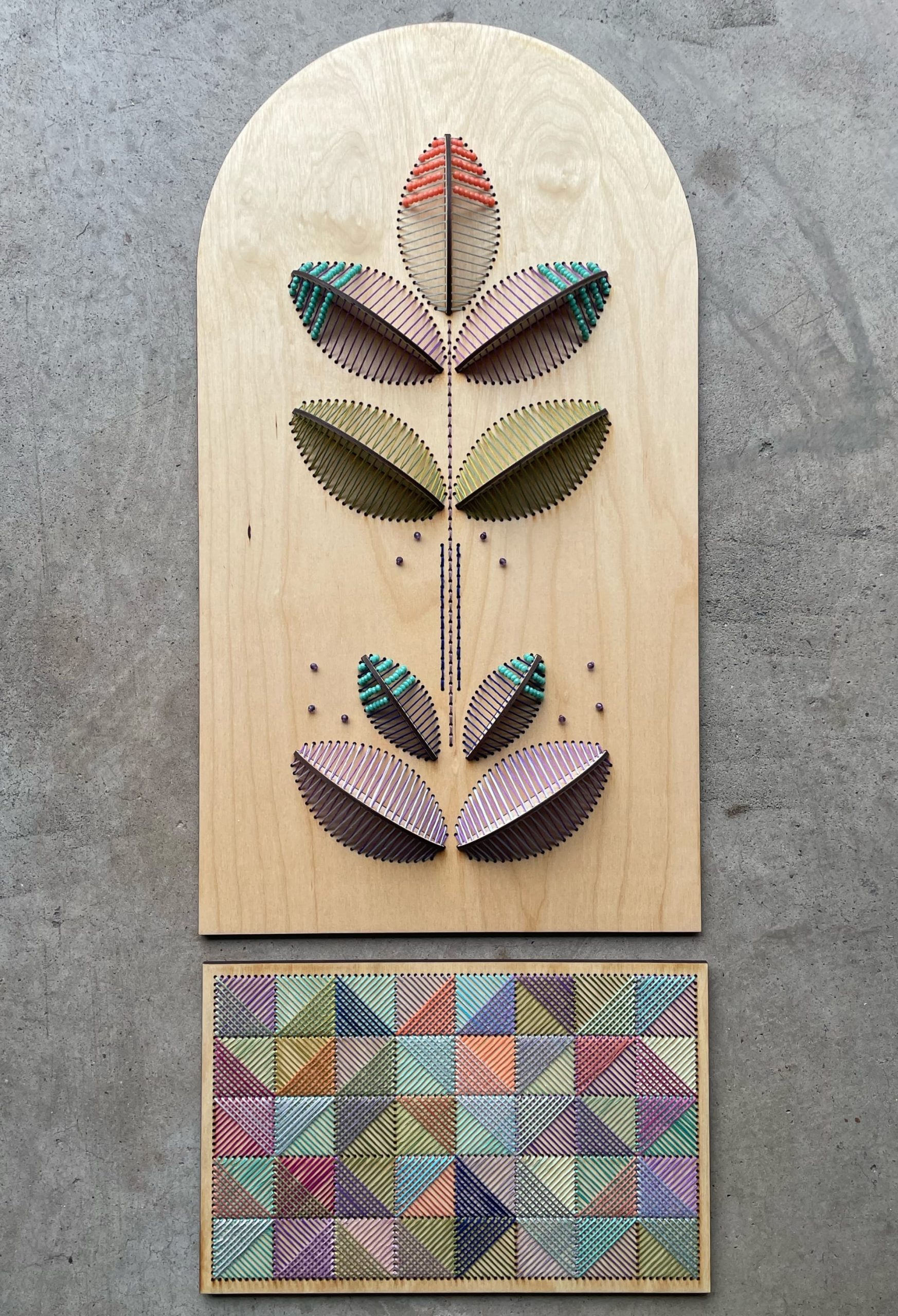 a sculptural floral embroidery on wood