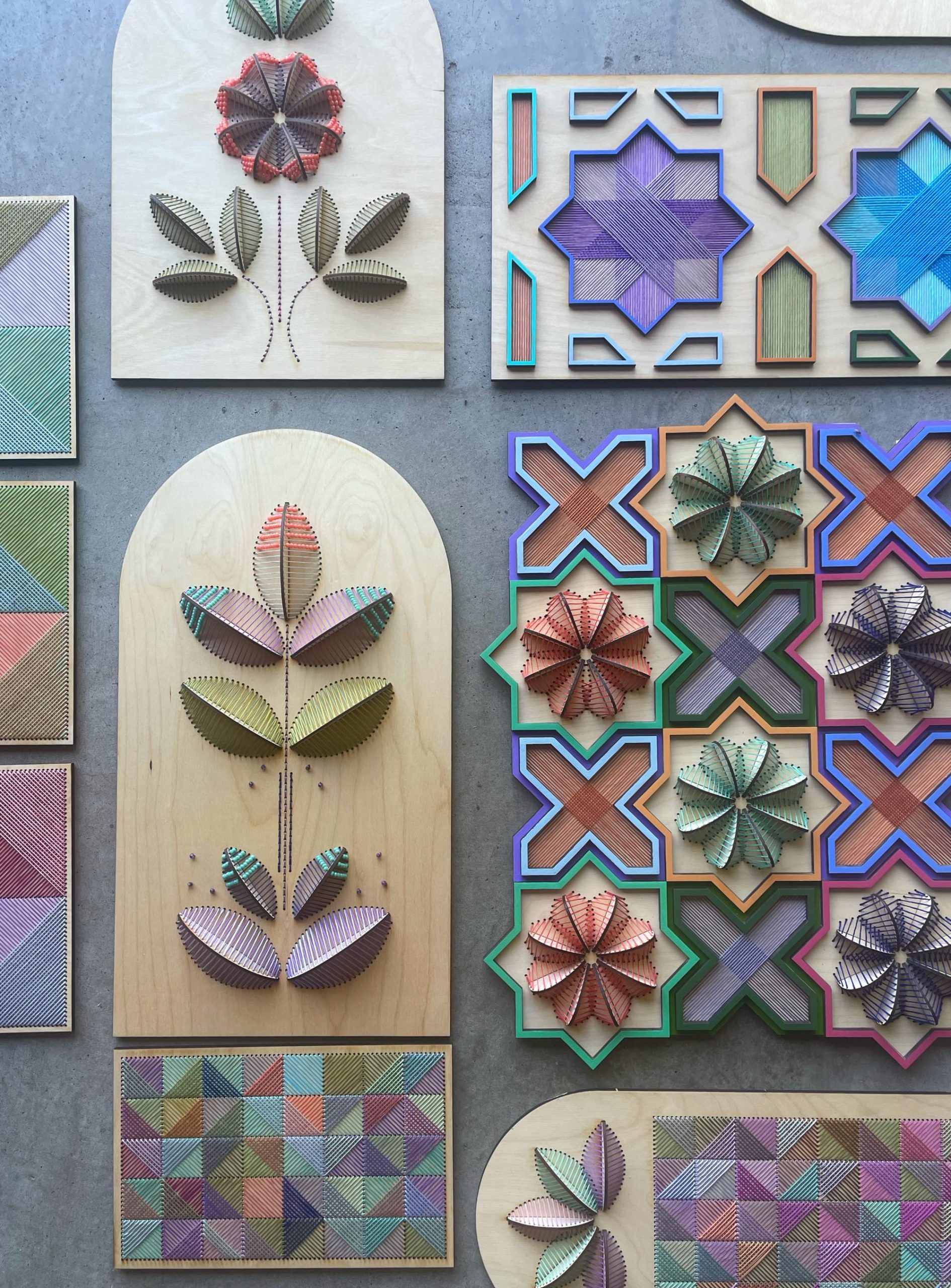 a collection of sculptural floral embroideries on wood