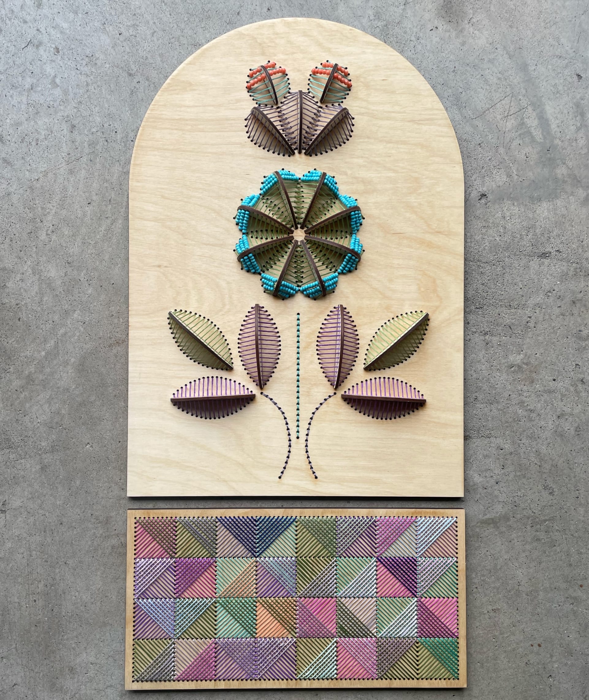 a sculptural floral embroidery on wood