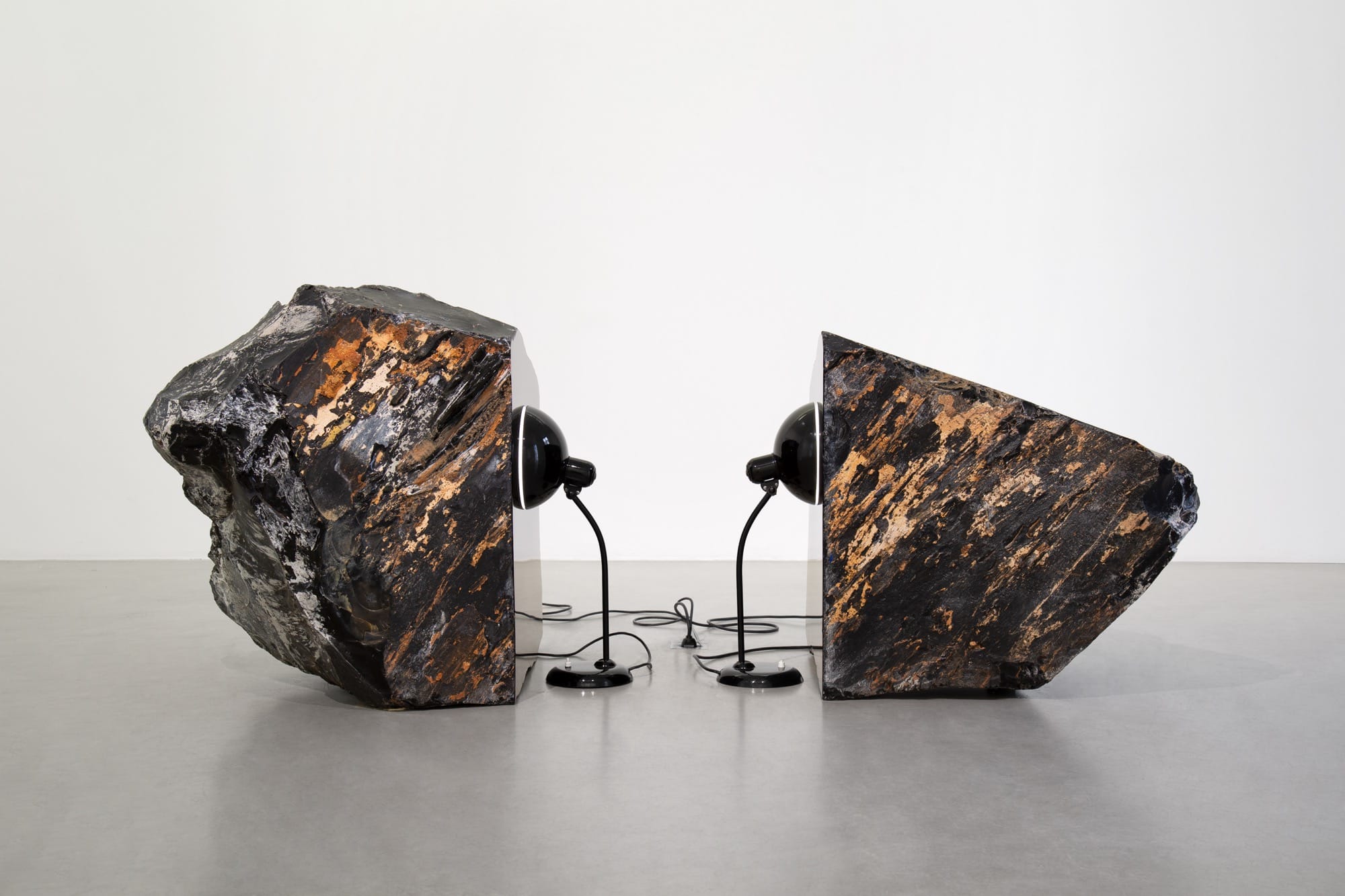 two stones with black lamps attached