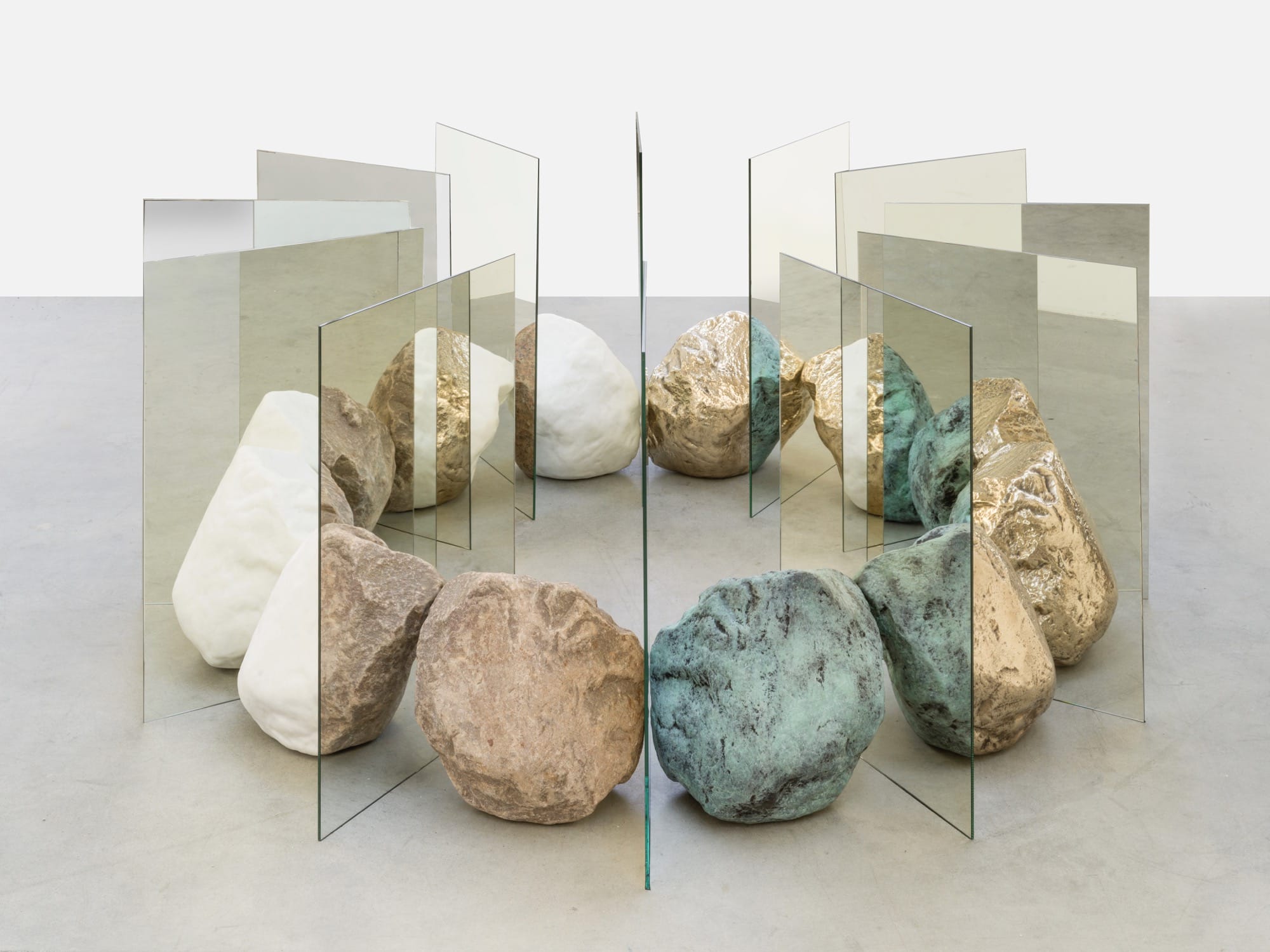 colorful stones arranged in a circle with mirrors slotted between them