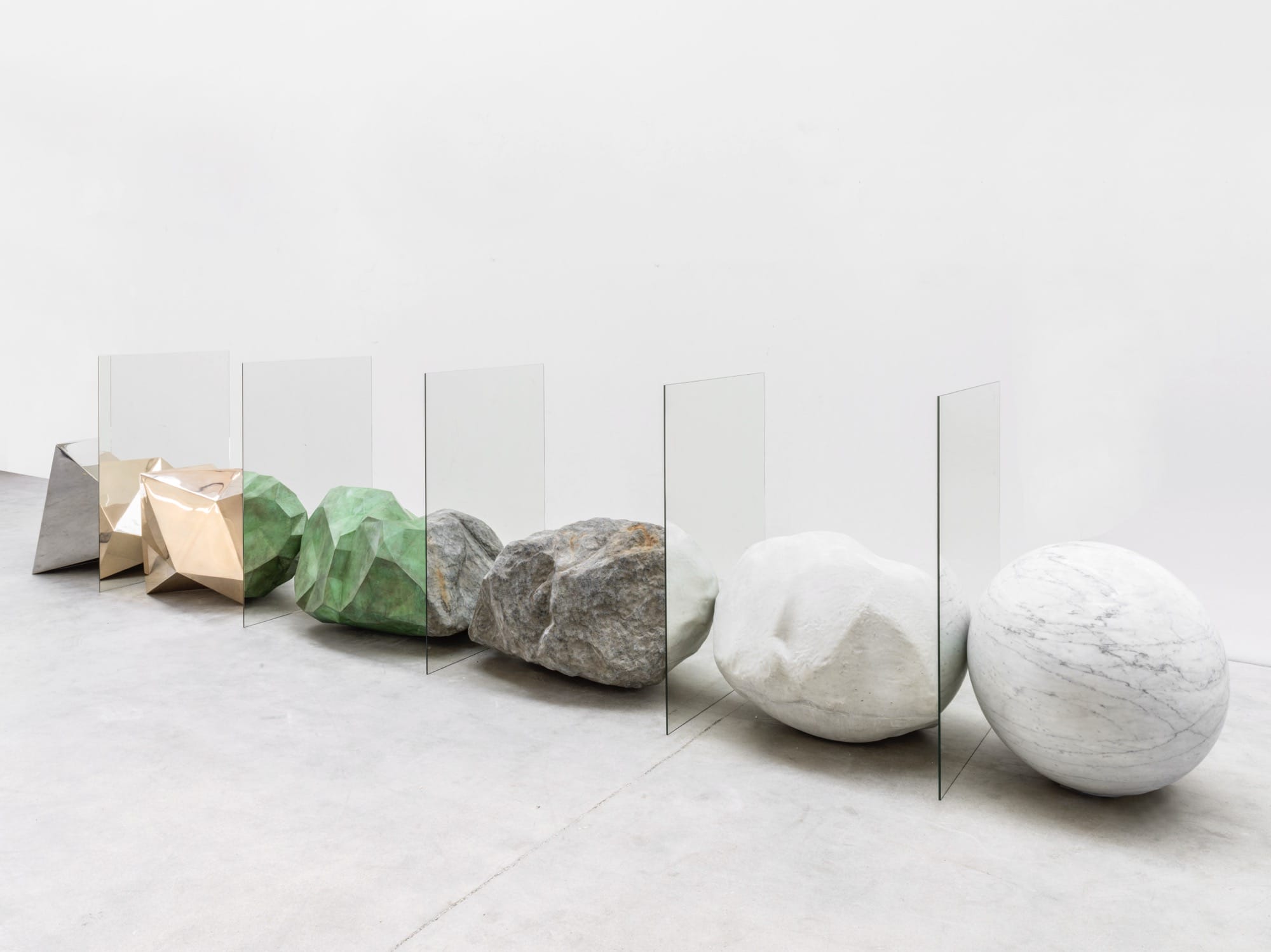 colorful stones arranged in a line with mirrors slotted between them