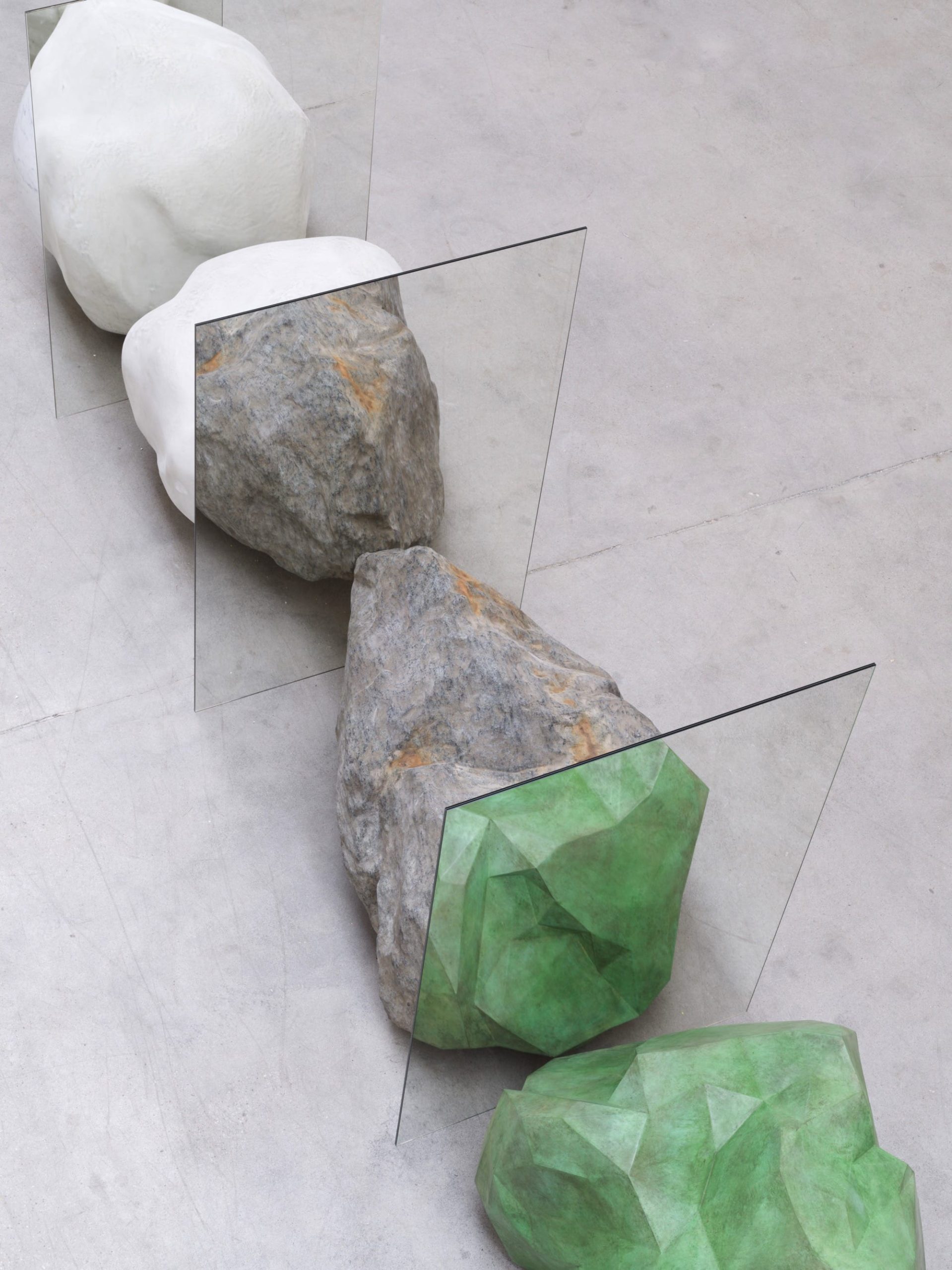 colorful stones arranged in a circle with mirrors slotted between them