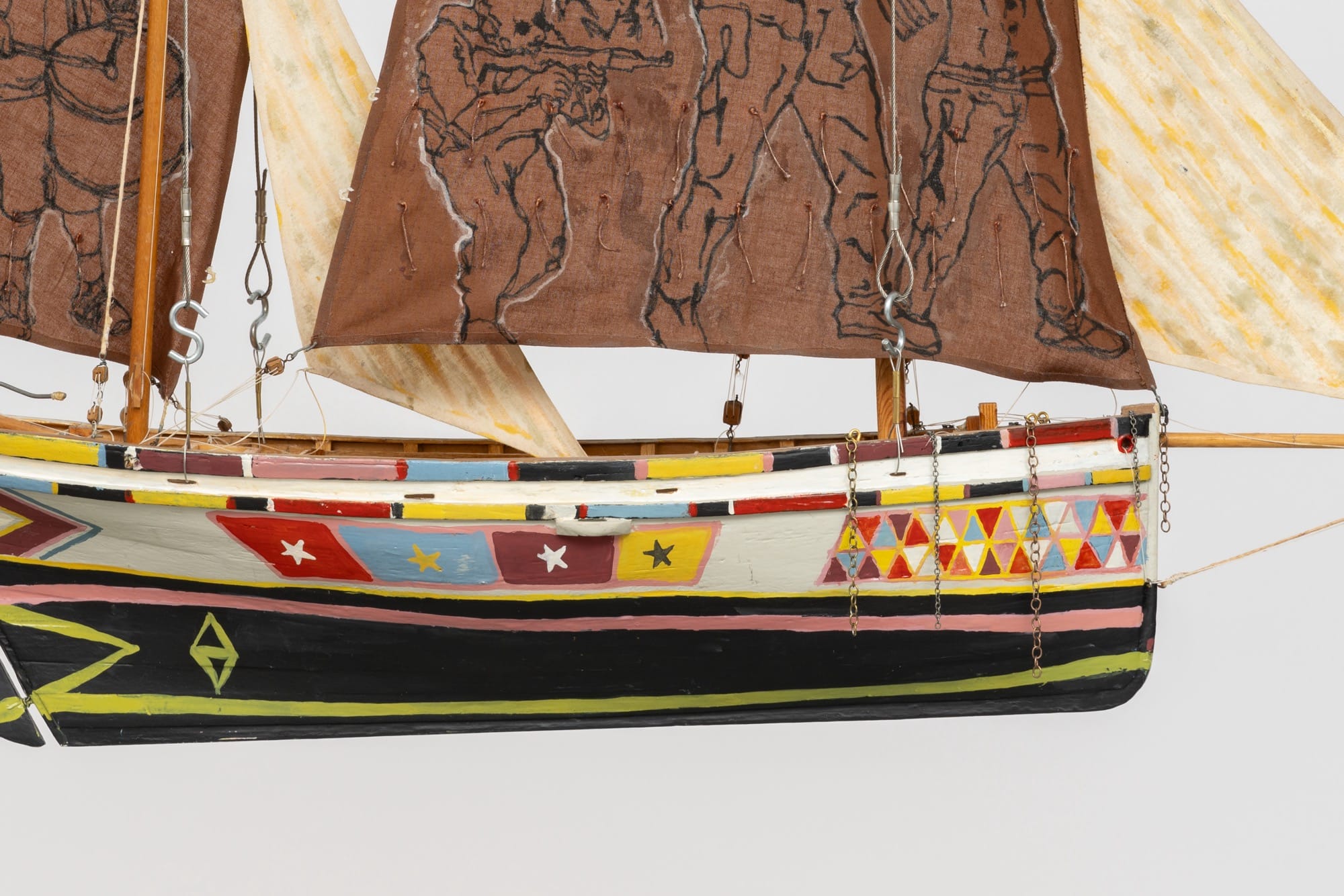 a detail of a sculpture of a boat with sails