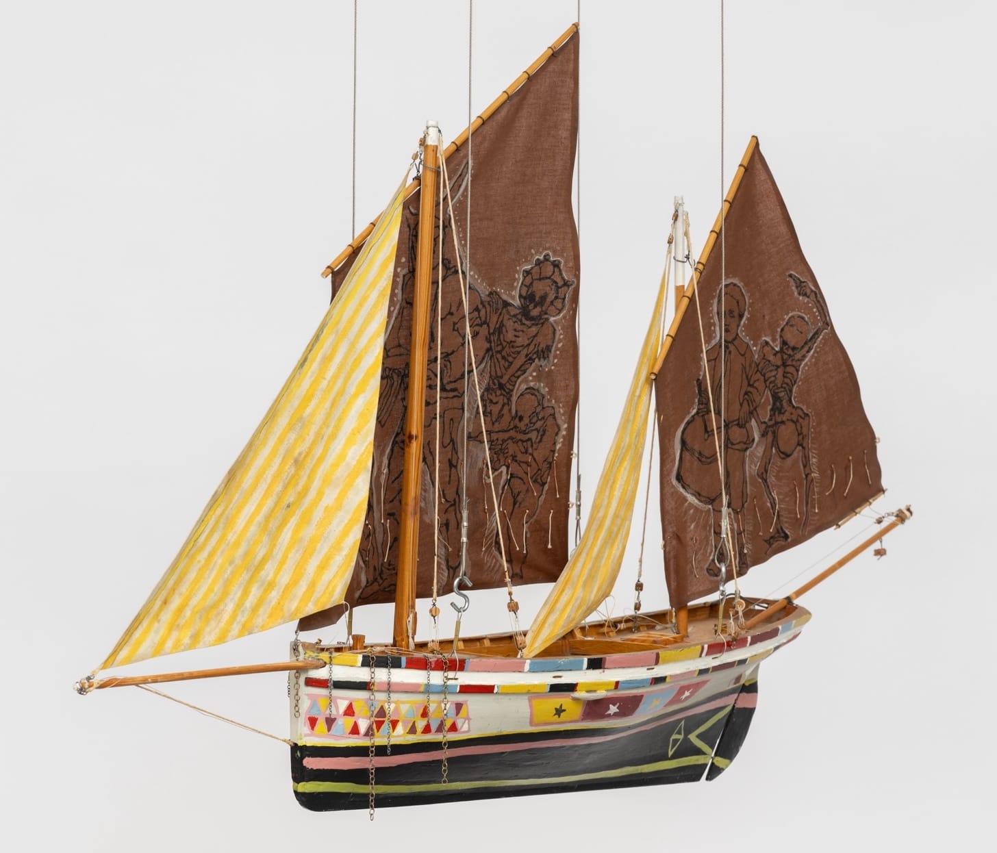 a sculpture of a boat with large sails