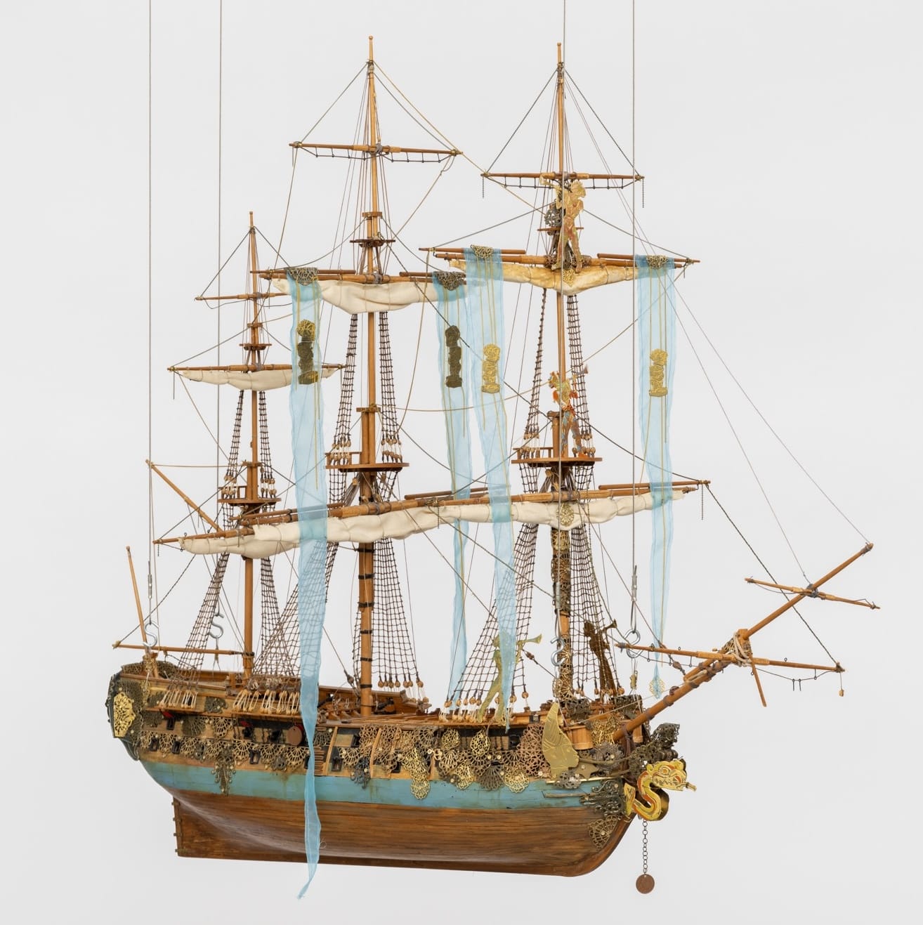 a sculpture of a wooden ship with giant masts