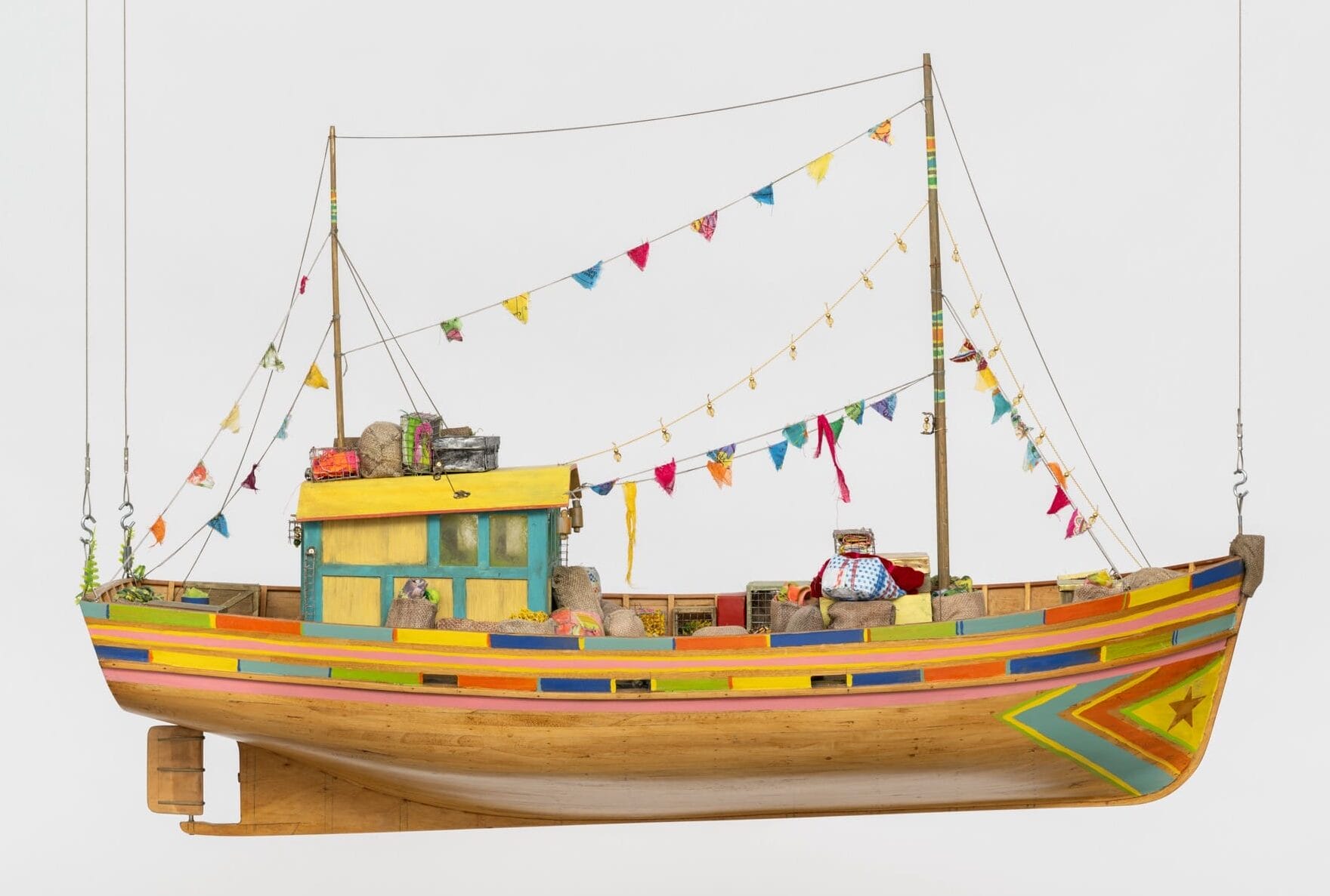 a sculpture of a boat with large sails