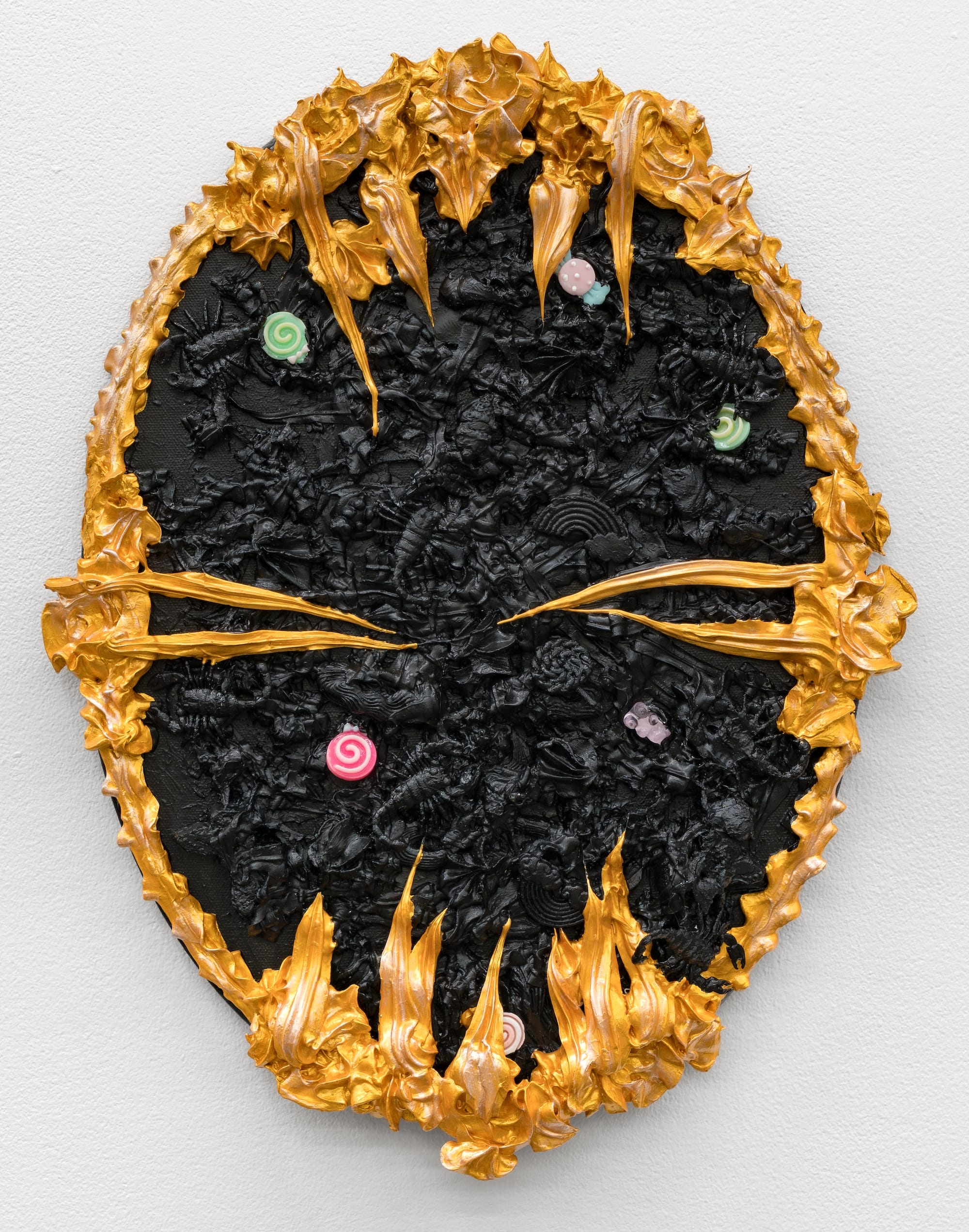 an oval mixed-media painting with textural gold and black paint