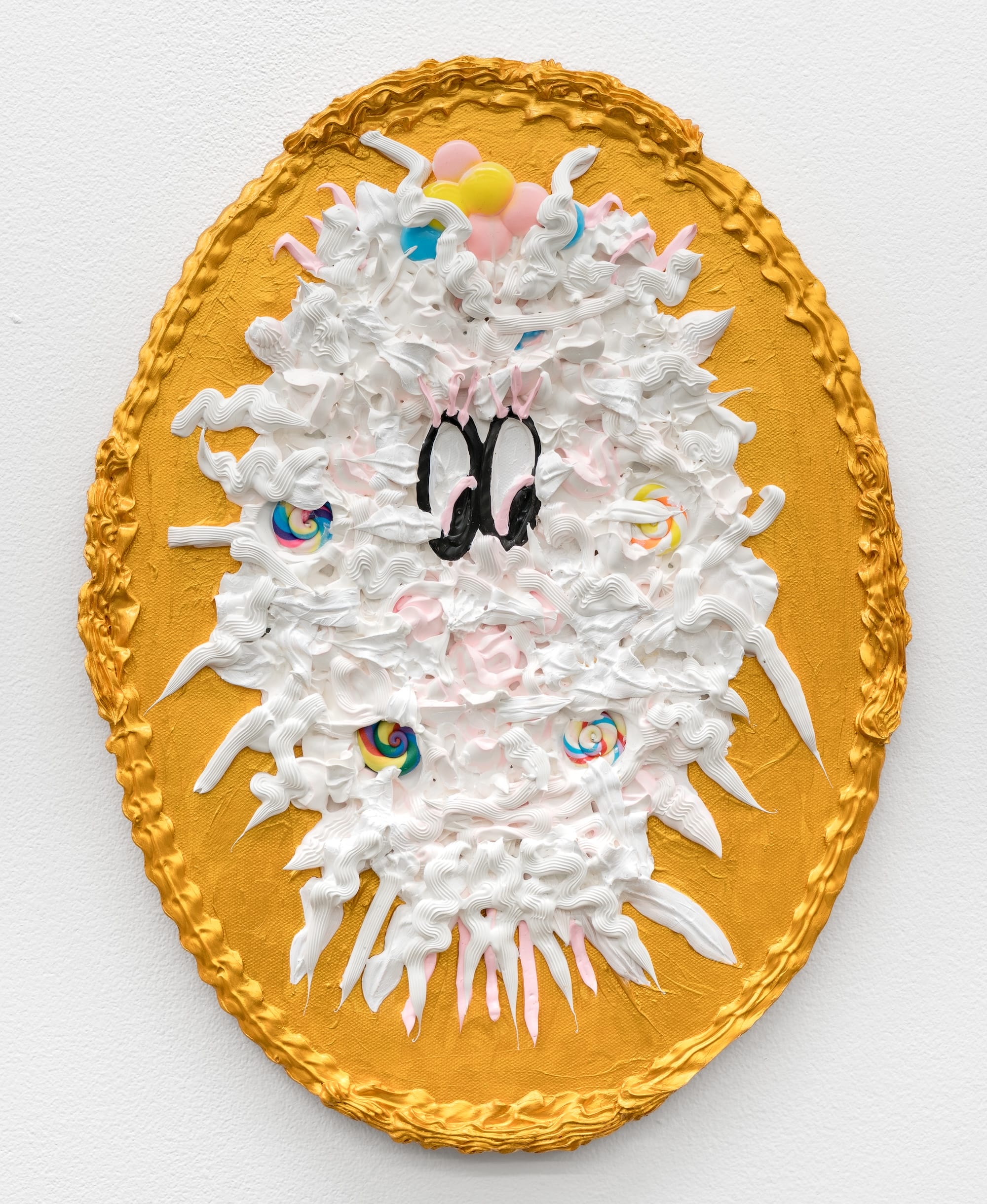 an oval mixed-media painting with textural gold and white paint