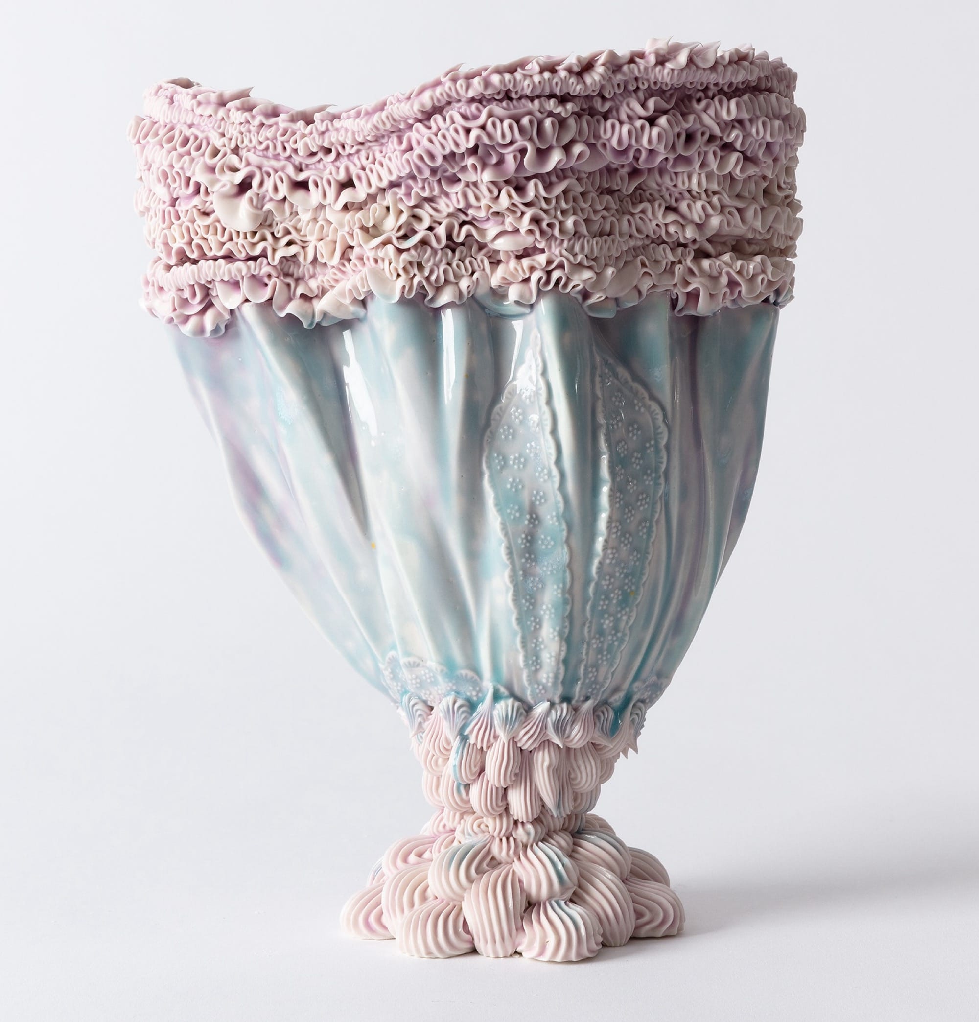 an elaborate, pastel-colored ceramic vase made with clay piped like frosting
