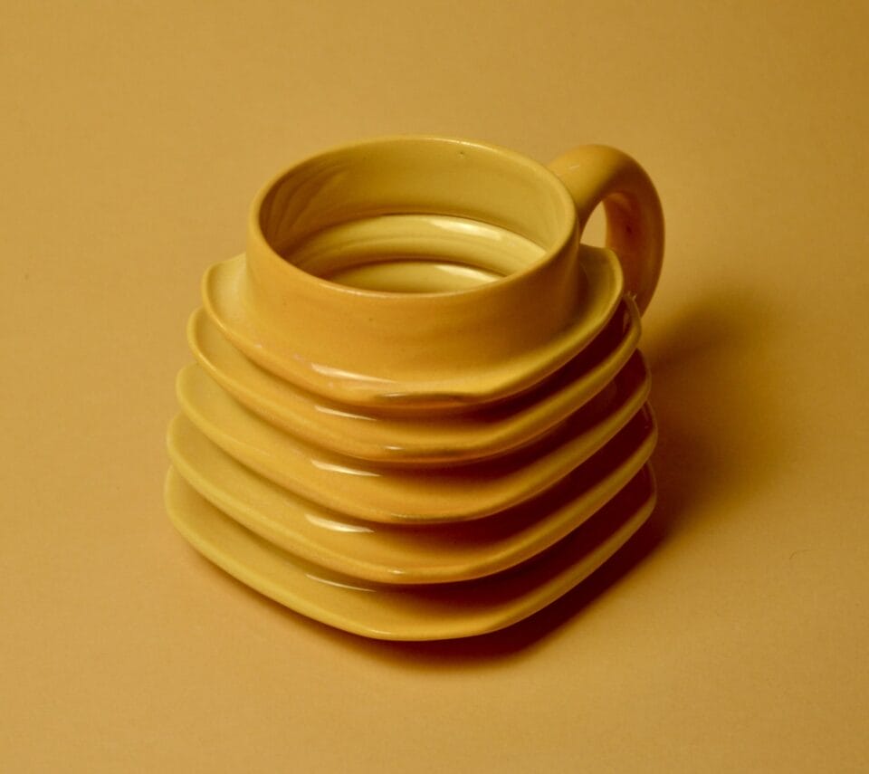 a geometric yellow mug with ribbed walls